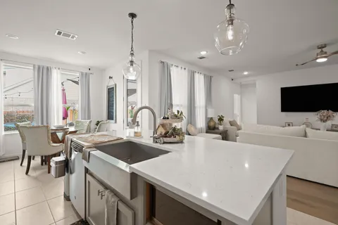 a large kitchen with a table and chairs
