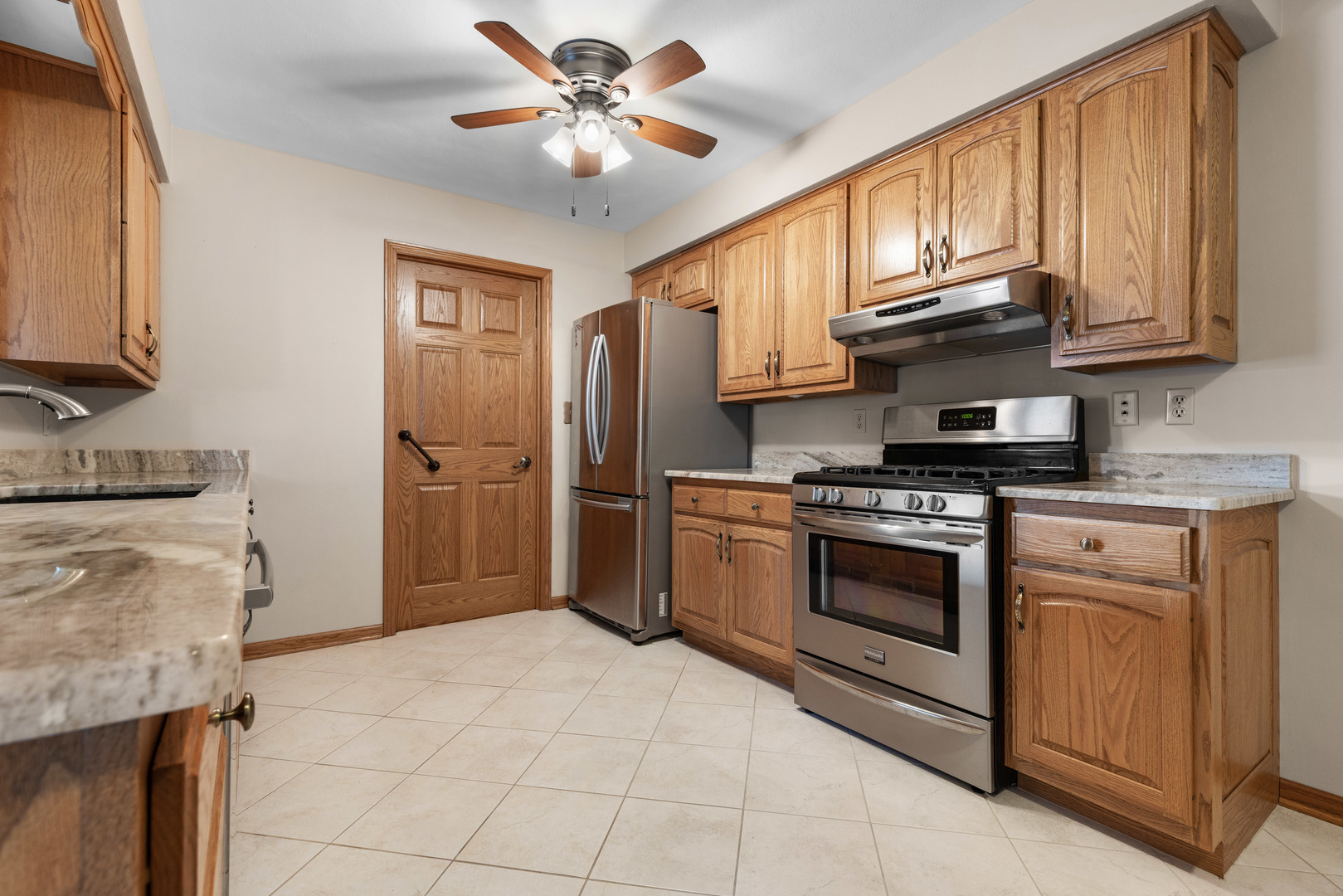 539 Riley Drive Marengo, IL 60152 - Photo 4 of 17 a kitchen with stainless steel appliances granite countertop a stove sink and cabinets