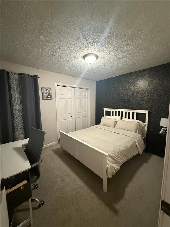 2400 Salem Drive Marietta, GA 30062 - Photo 13 of 16 a spacious bedroom with a bed and a desk in it