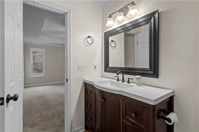 a bathroom with a sink vanity and a mirror