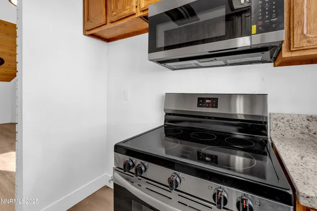 a stove top oven sitting inside of a kitchen