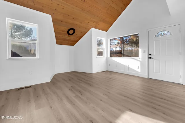 a view of an entryway with wooden floor