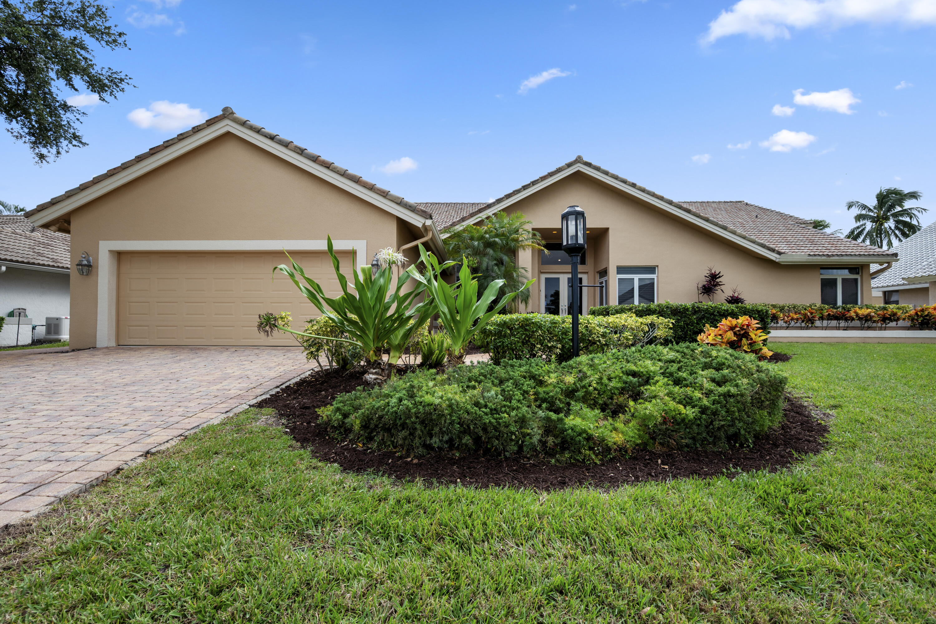 a front view of house with a yard and green space