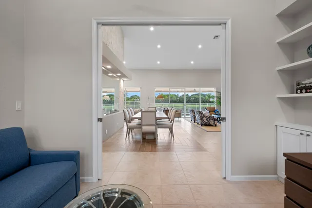 a living room with stainless steel appliances furniture and a flat screen tv