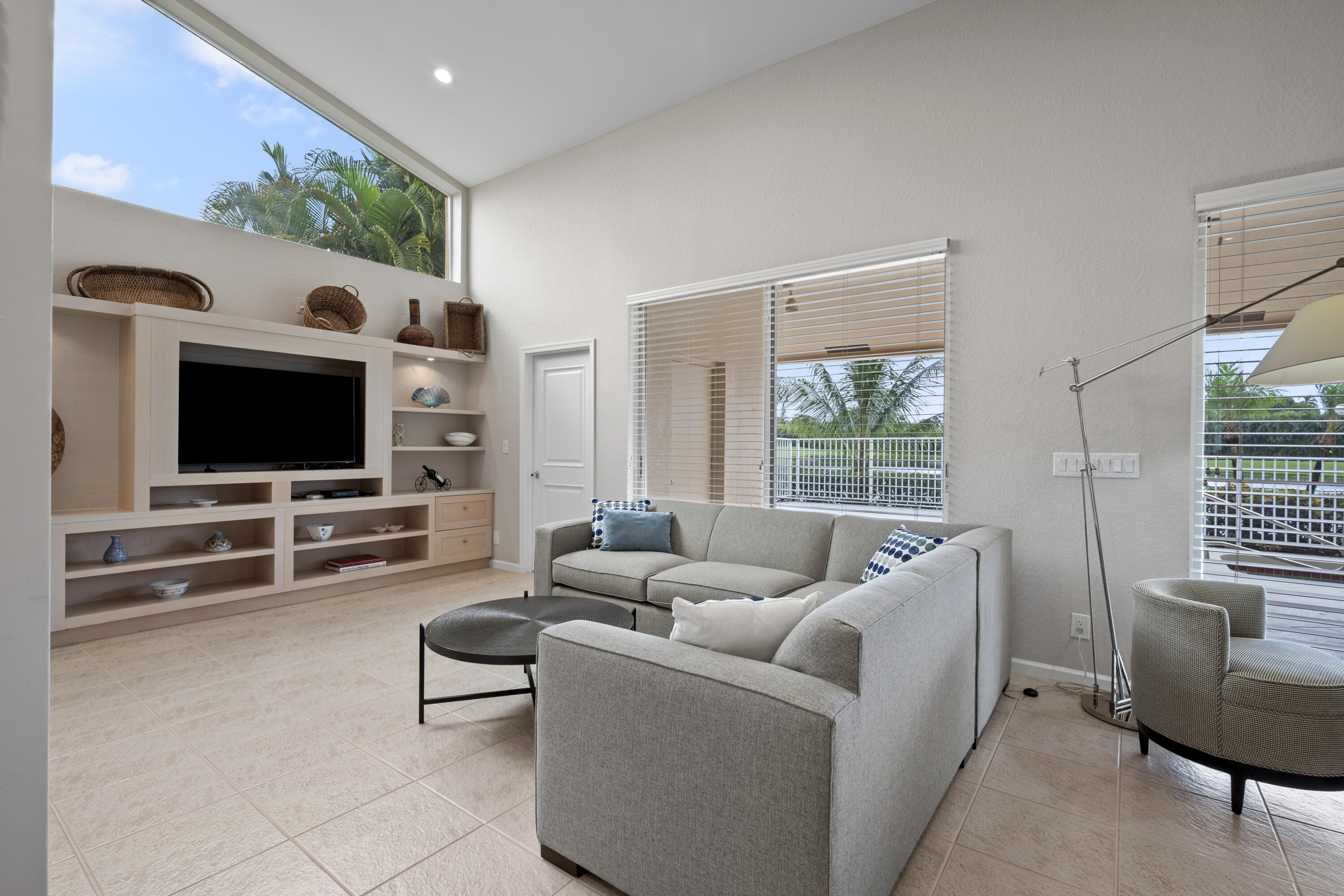 10670 Stonebridge Boulevard Boca Raton, FL 33498 - Photo 24 of 58 a living room with furniture and a flat screen tv