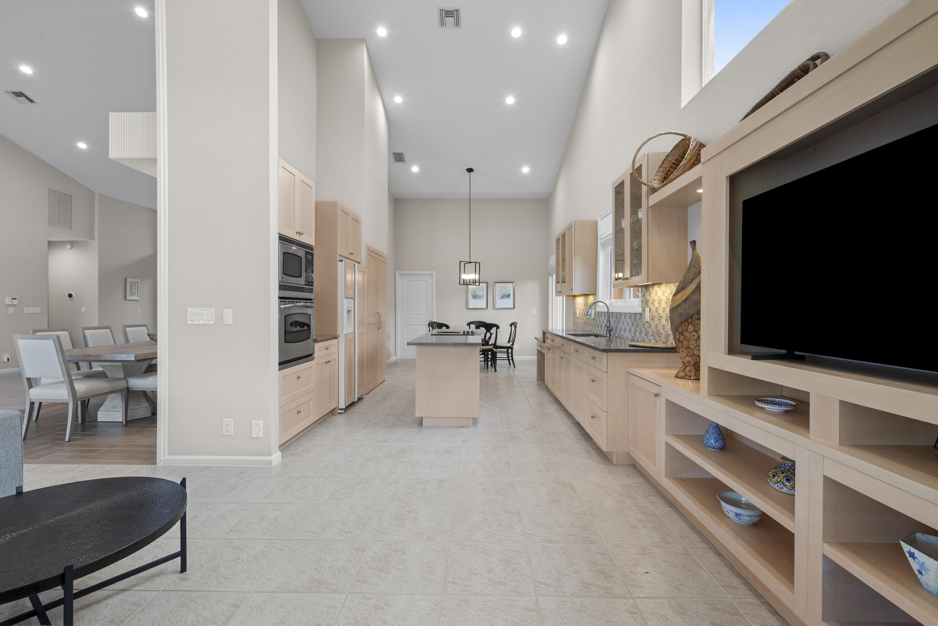 10670 Stonebridge Boulevard Boca Raton, FL 33498 - Photo 27 of 58 a living room with stainless steel appliances furniture and a flat screen tv