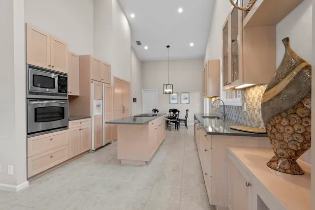 a kitchen with granite countertop a stove and a sink