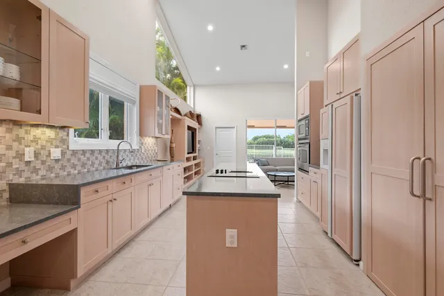a spacious bedroom with a bed and a chandelier