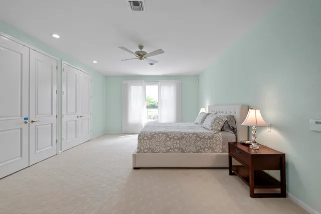 a spacious bedroom with a bed a couch and a window