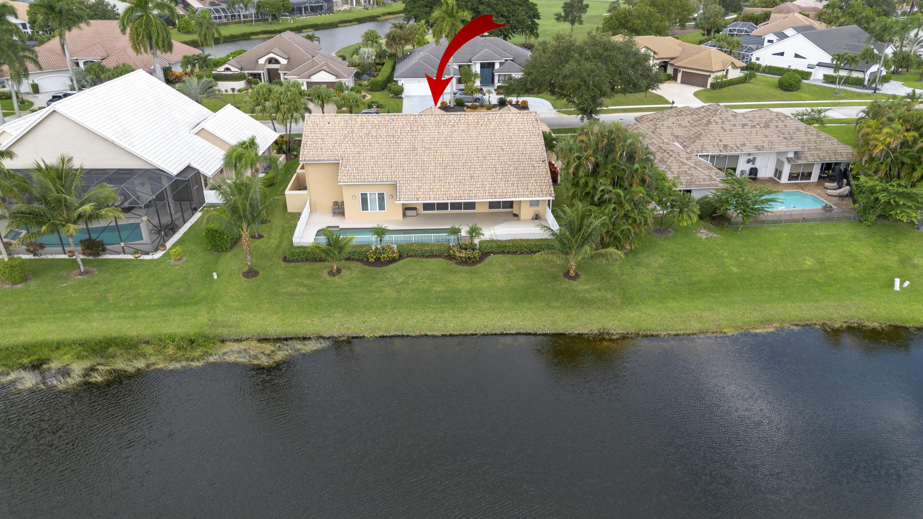 10670 Stonebridge Boulevard Boca Raton, FL 33498 - Photo 4 of 58 an aerial view of a house with a yard and lake view