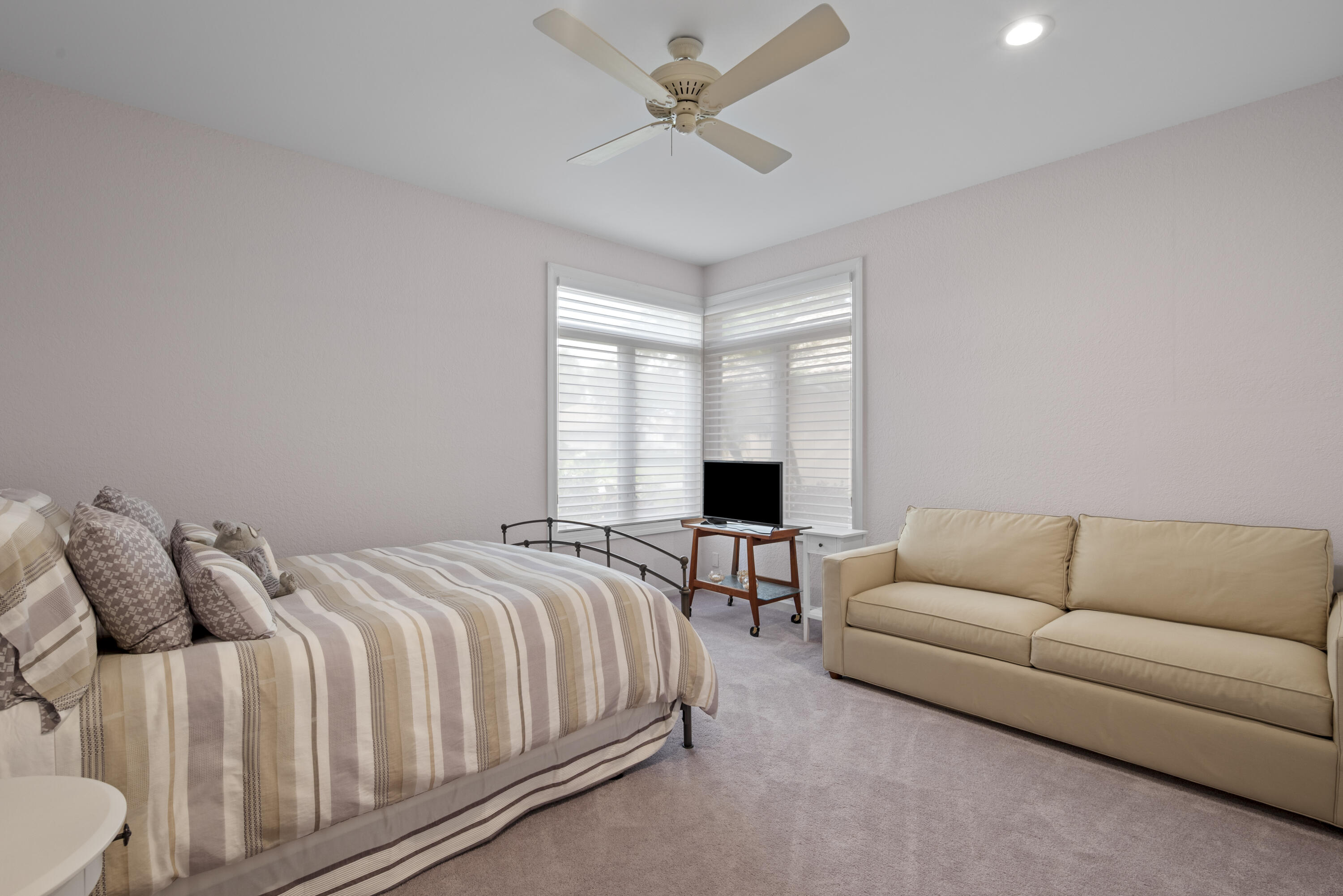 10670 Stonebridge Boulevard Boca Raton, FL 33498 - Photo 41 of 58 a spacious bedroom with a bed a couch and a window