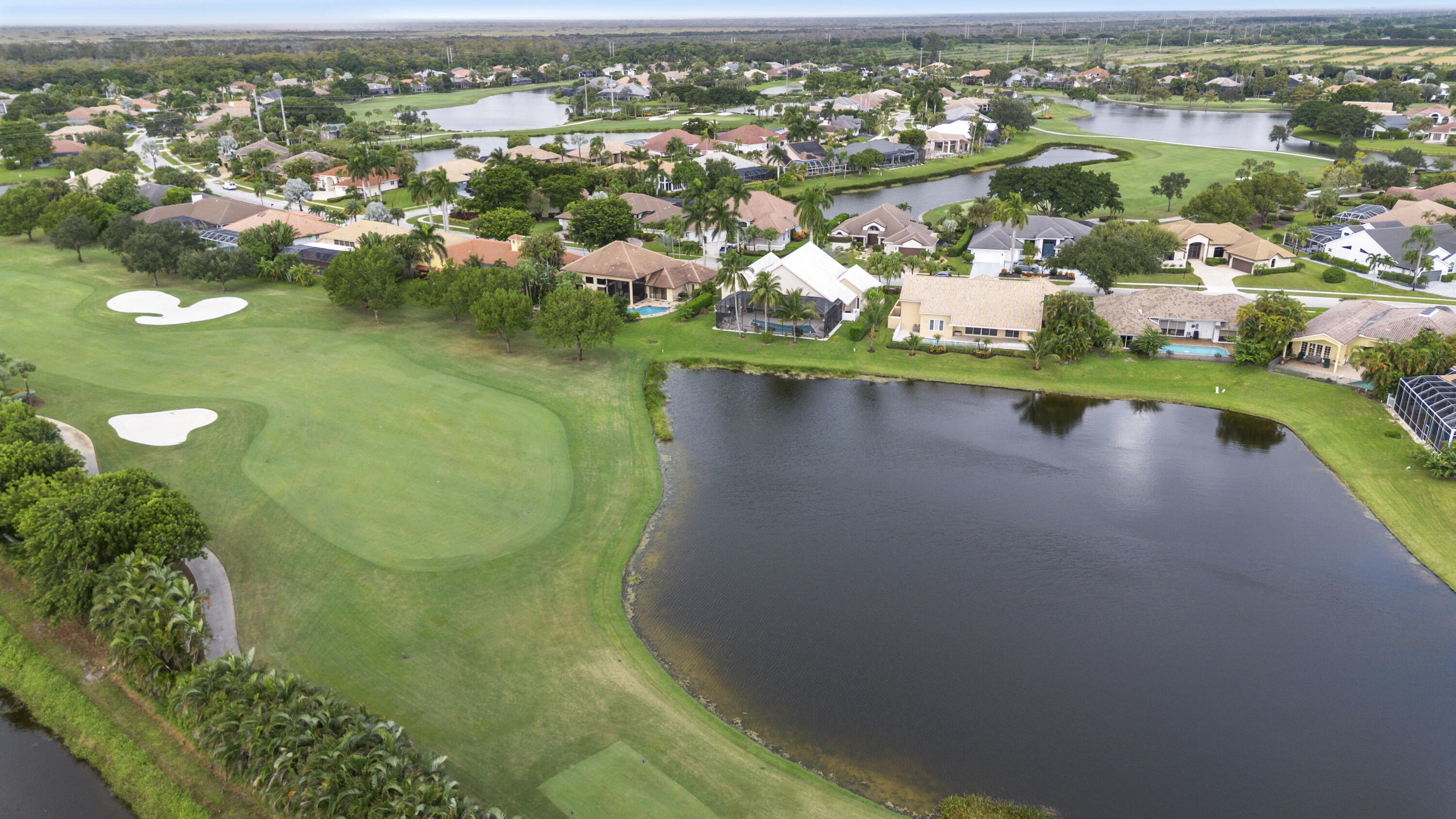 10670 Stonebridge Boulevard Boca Raton, FL 33498 - Photo 54 of 58 an aerial view of residential houses with outdoor space and trees