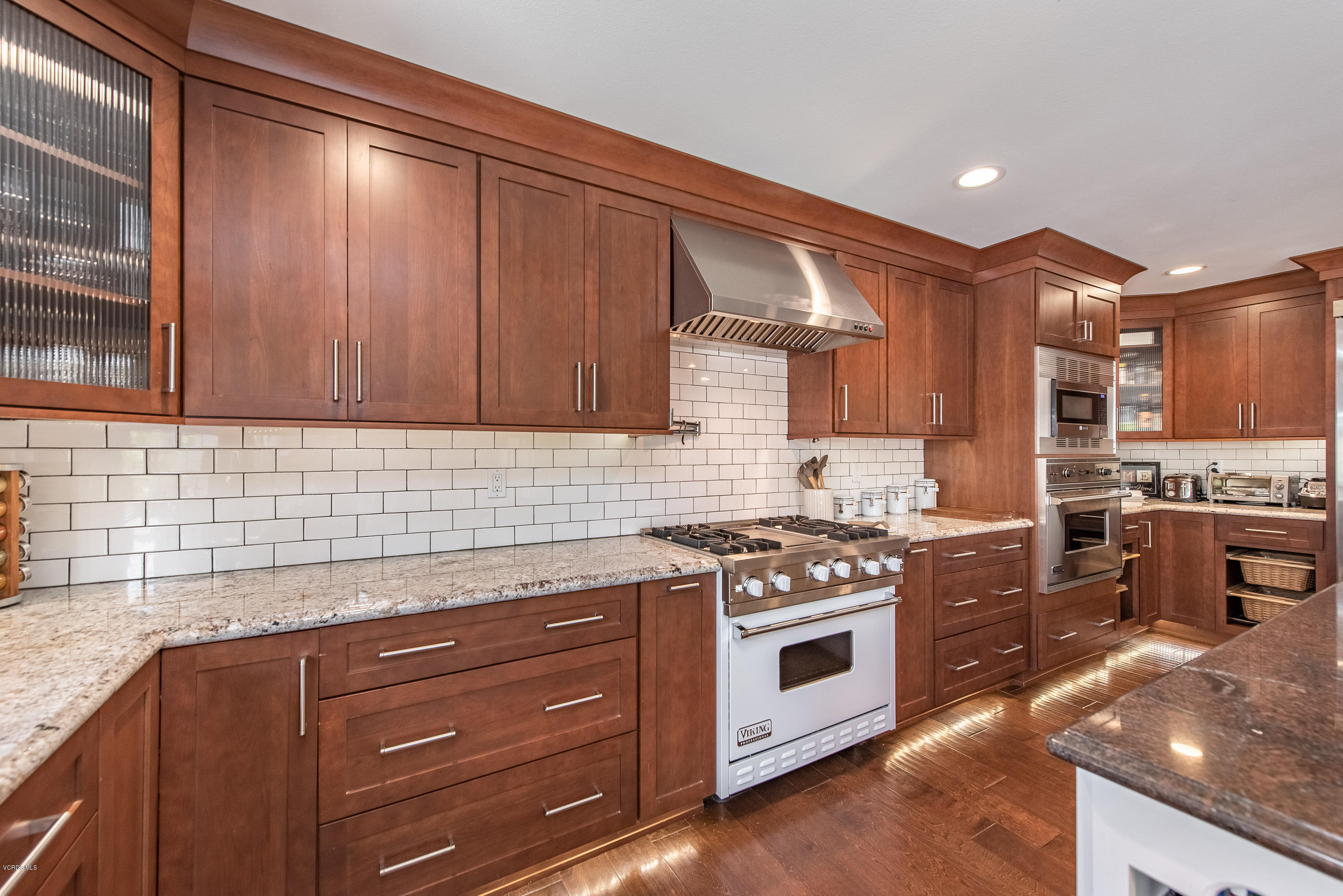 1242 Rambling Road Simi Valley, CA 93065 - Photo 12 of 81 a kitchen with granite countertop wooden cabinets and stainless steel appliances