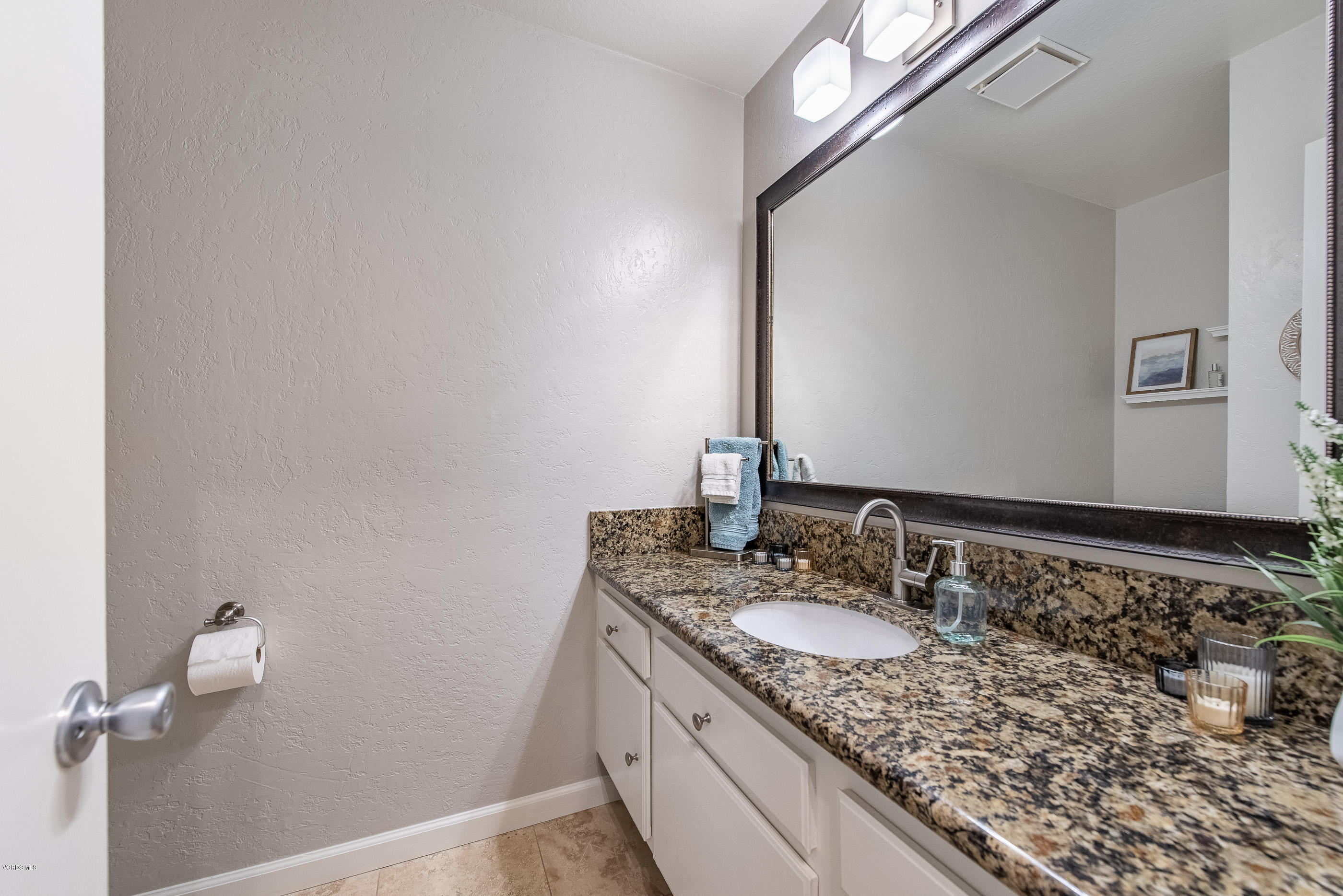 1242 Rambling Road Simi Valley, CA 93065 - Photo 26 of 81 a bathroom with a granite countertop sink and a mirror