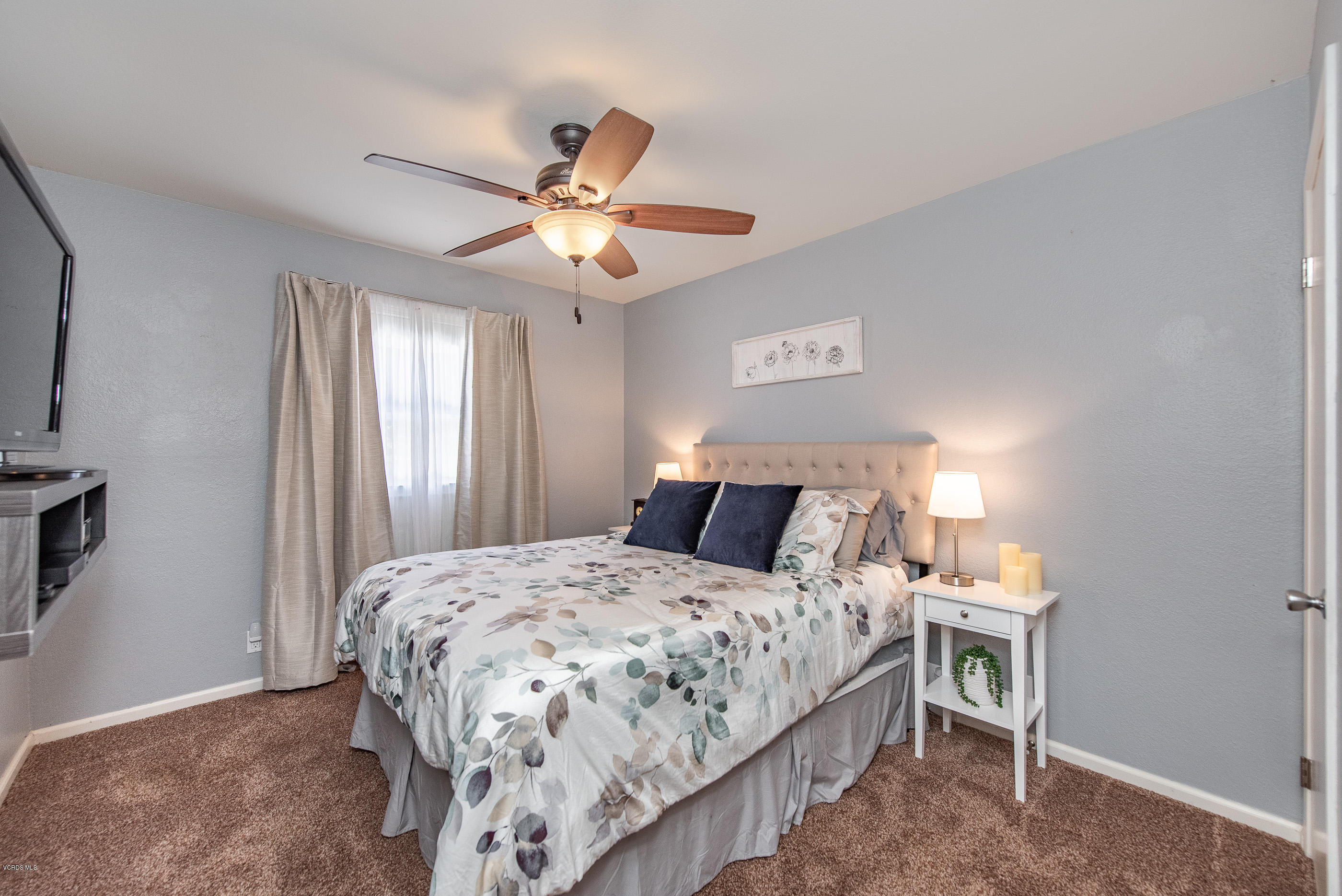 1242 Rambling Road Simi Valley, CA 93065 - Photo 36 of 81 a bedroom with a large bed and a chandelier