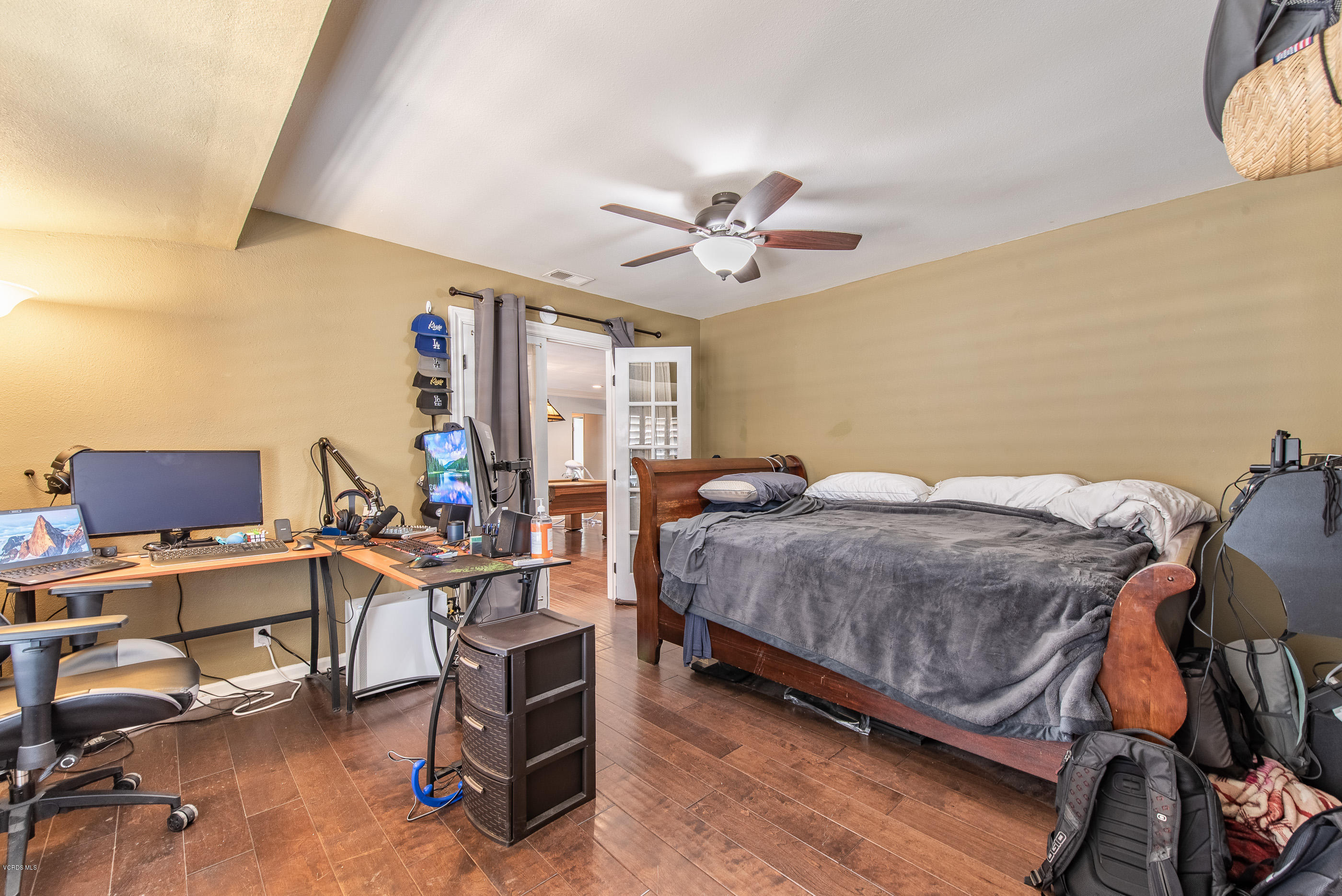 1242 Rambling Road Simi Valley, CA 93065 - Photo 38 of 81 a bedroom with a bed and a chandelier