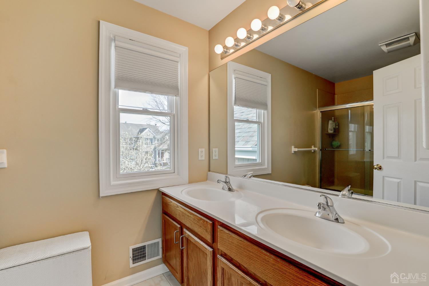 33 Edinburg Circle Old Bridge, NJ 07747 - Photo 28 of 51 a bathroom with a sink a vanity and a mirror