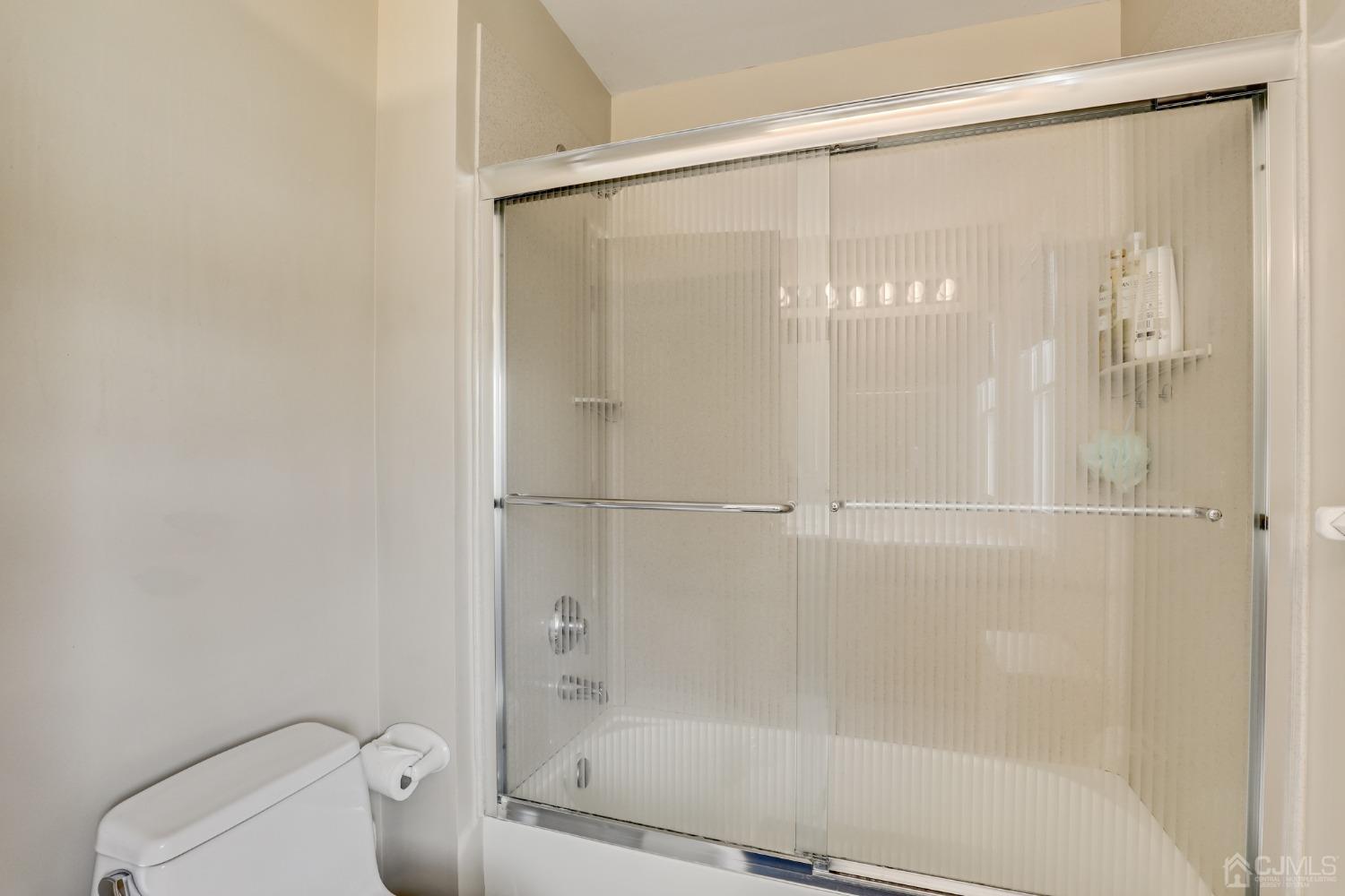 33 Edinburg Circle Old Bridge, NJ 07747 - Photo 29 of 51 a bathroom with a glass shower door