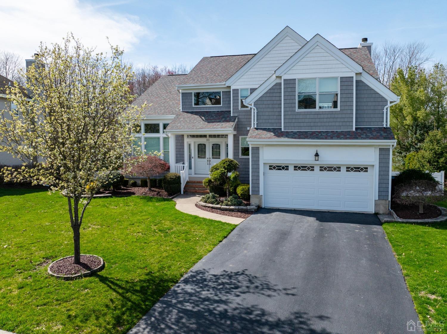 33 Edinburg Circle Old Bridge, NJ 07747 - Photo 3 of 51 a front view of a house with a garden and trees