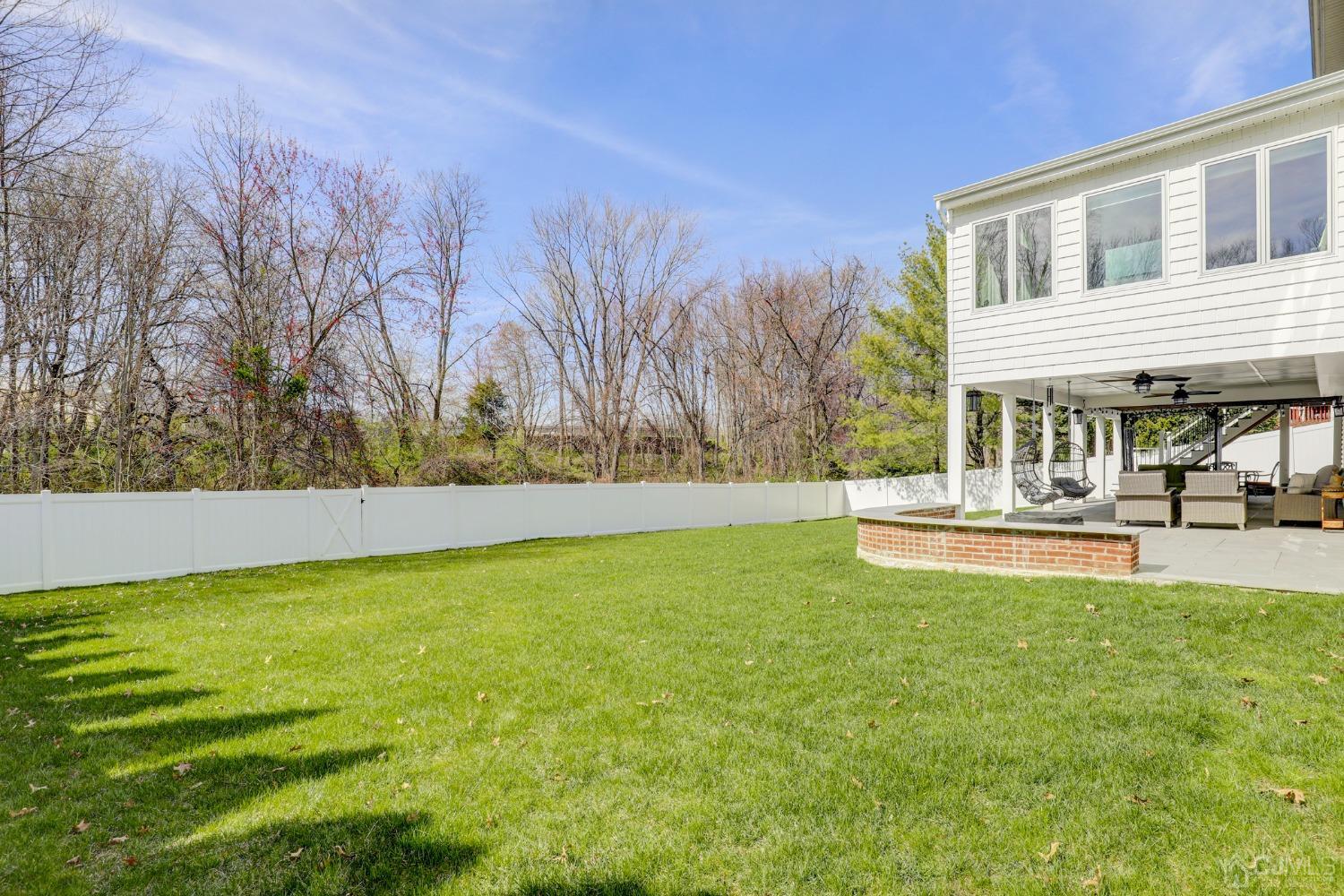 33 Edinburg Circle Old Bridge, NJ 07747 - Photo 44 of 51 a view of swimming pool with lawn chairs and large trees
