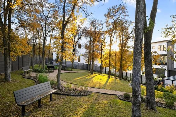 a view of swimming pool with seating area and trees around