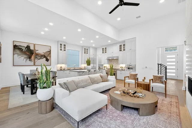 a living room with furniture and a dining table with kitchen view