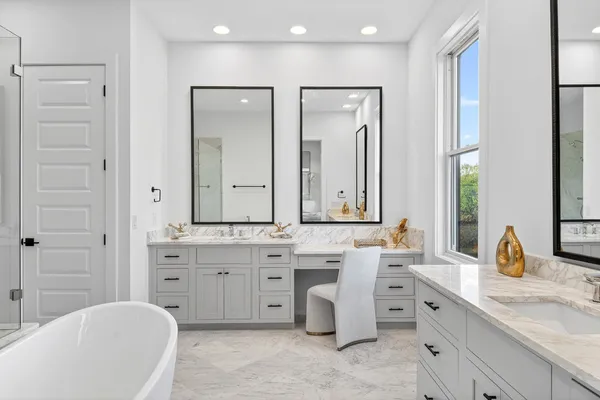 a spacious bathroom with a double vanity sink mirror and double