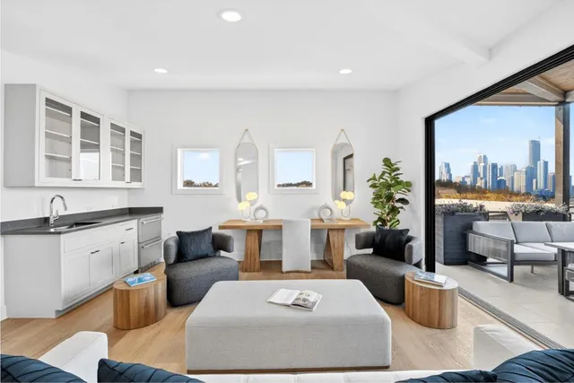 a living room with furniture and a floor to ceiling window