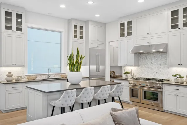 a kitchen with stainless steel appliances granite countertop a sink and cabinets