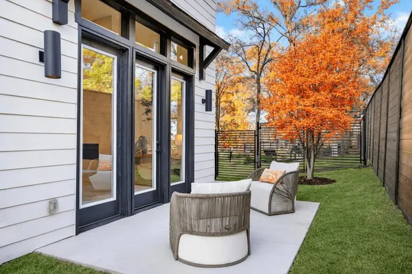 a view of a patio with couches chairs and a yard