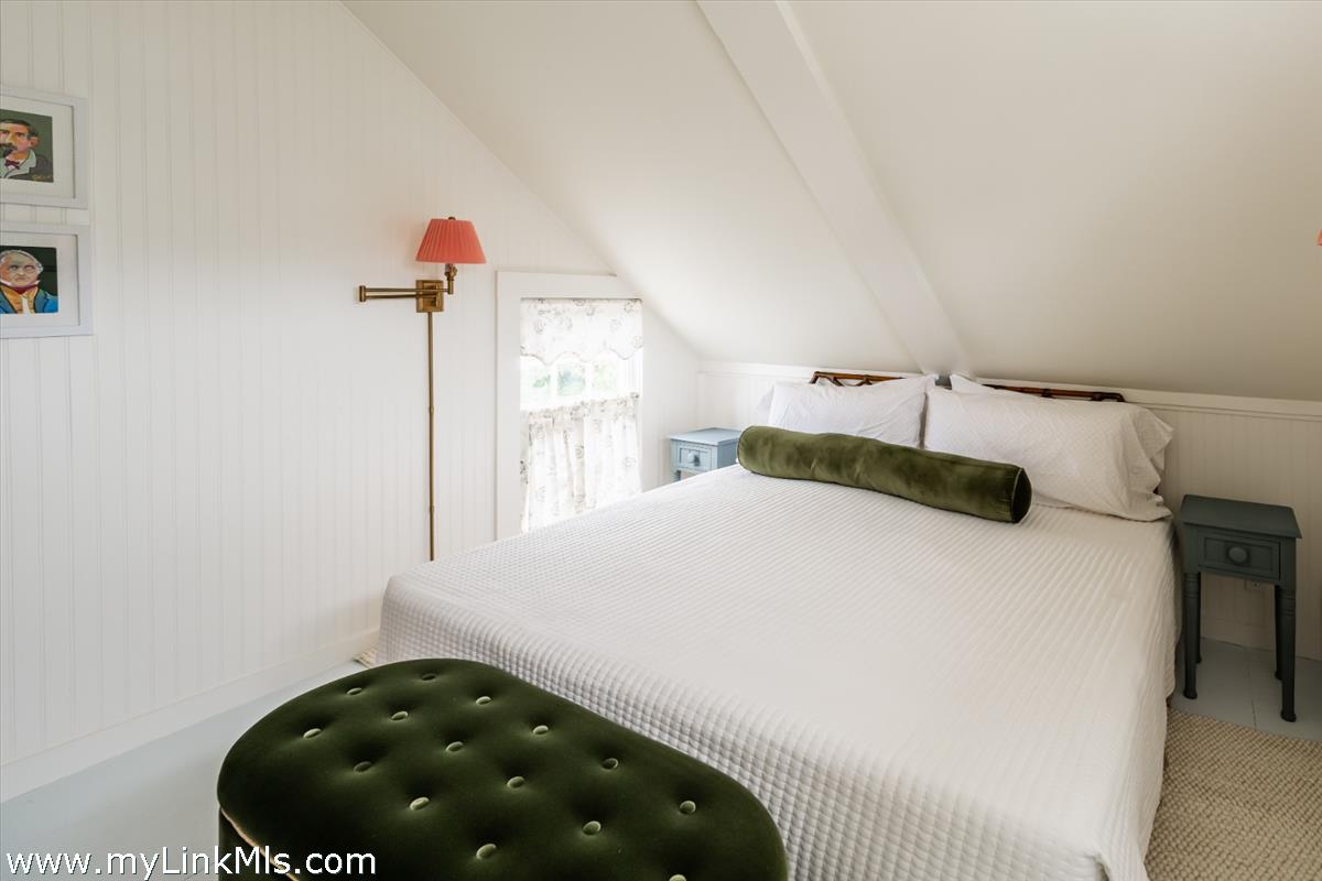 10 Centre Street Nantucket, MA 02554 - Photo 38 of 43 a bedroom with a bed and a chandelier