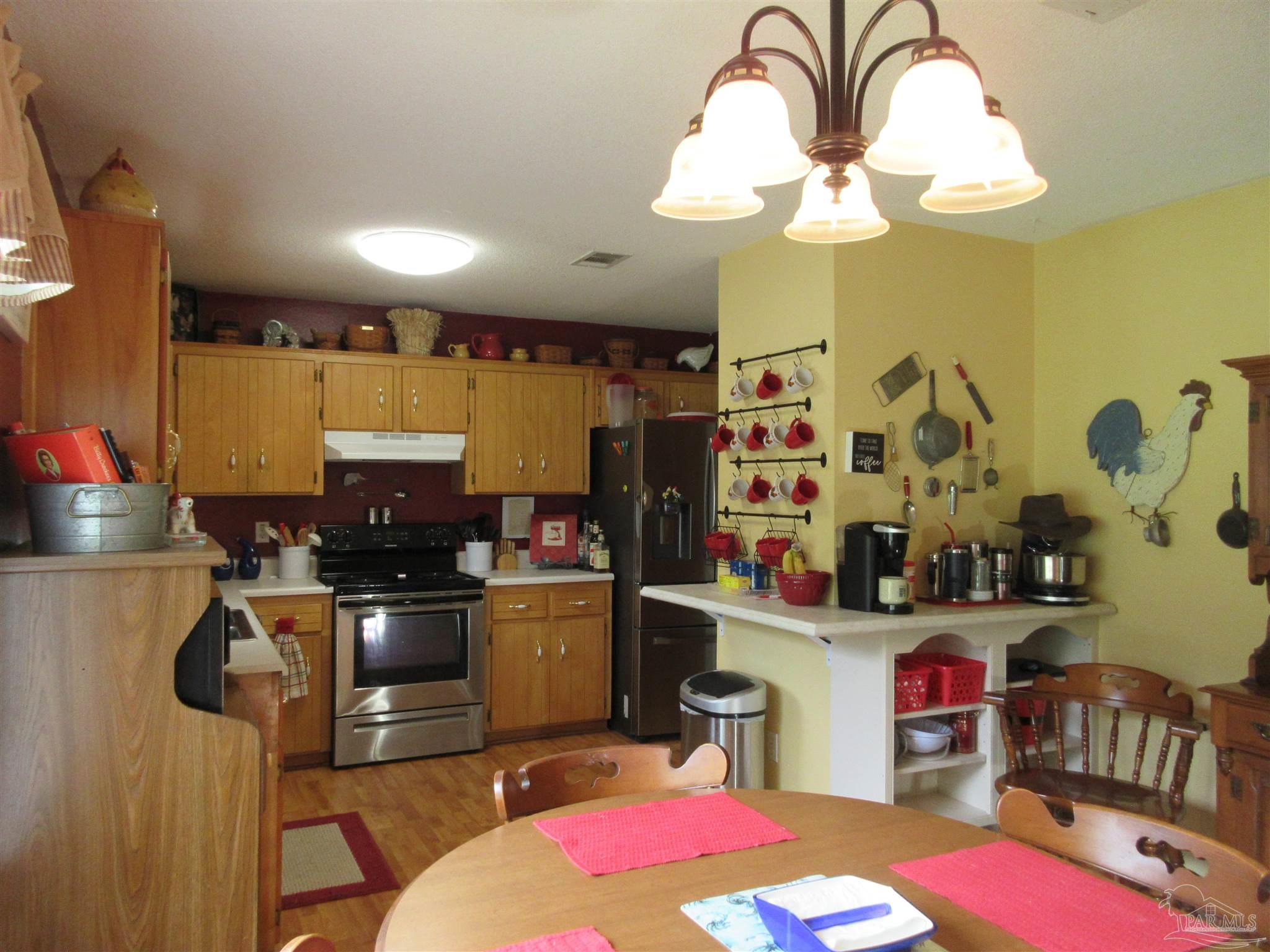4523 Struth Lane Pace, FL 32571 - Photo 15 of 49 a kitchen with a sink appliances and cabinets
