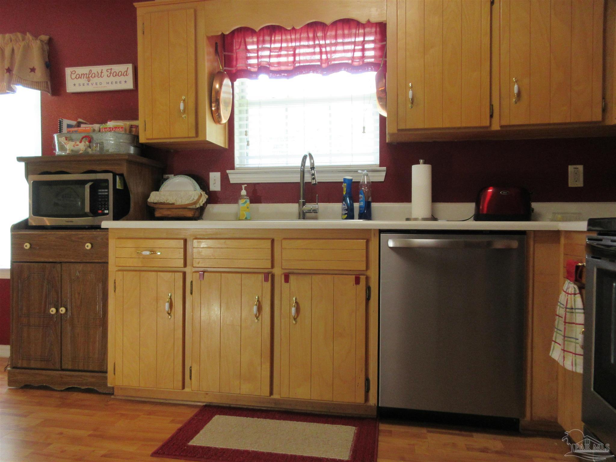 4523 Struth Lane Pace, FL 32571 - Photo 19 of 49 a kitchen with stainless steel appliances granite countertop a sink window and cabinets