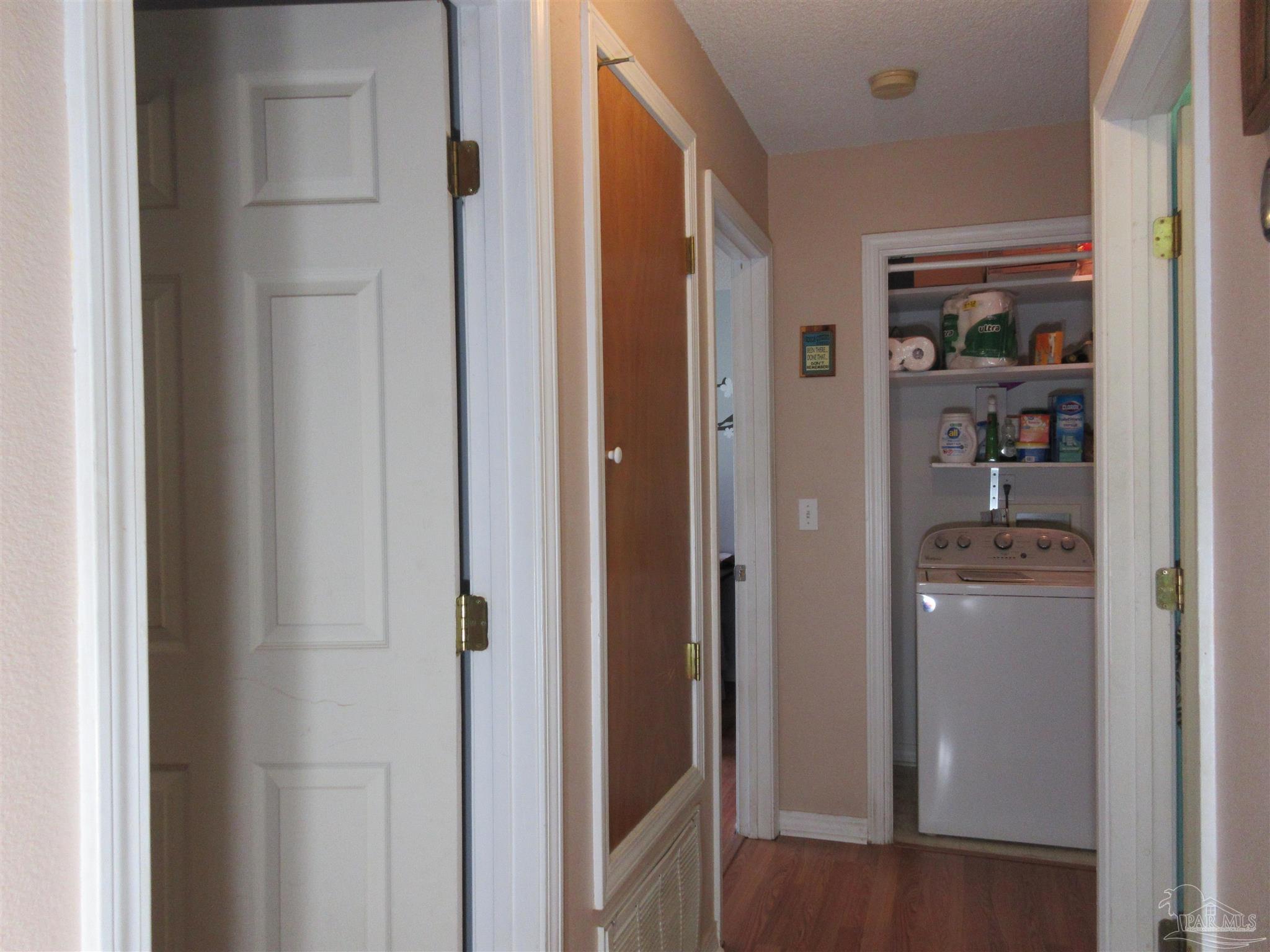 4523 Struth Lane Pace, FL 32571 - Photo 20 of 49 a view of a hallway with wooden shelves