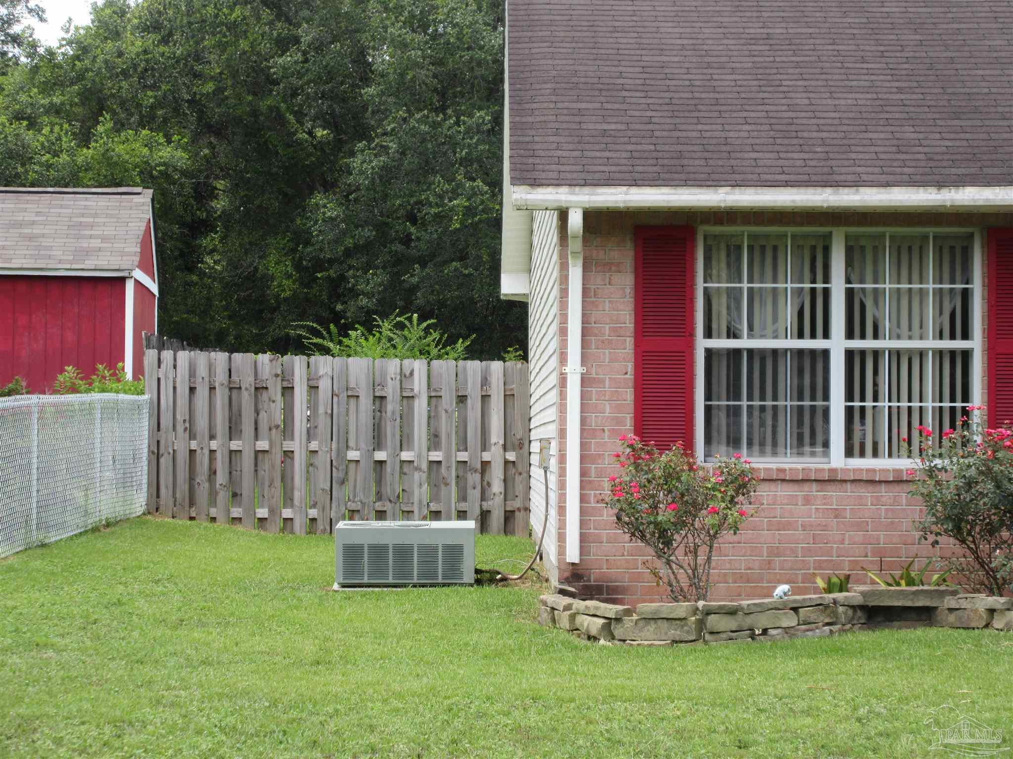 4523 Struth Lane Pace, FL 32571 - Photo 42 of 49 a view of a house with a small yard and wooden fence