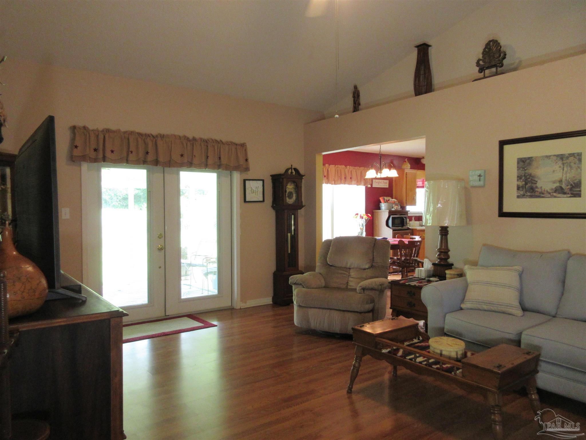 4523 Struth Lane Pace, FL 32571 - Photo 9 of 49 a living room with furniture wooden floor and a flat screen tv