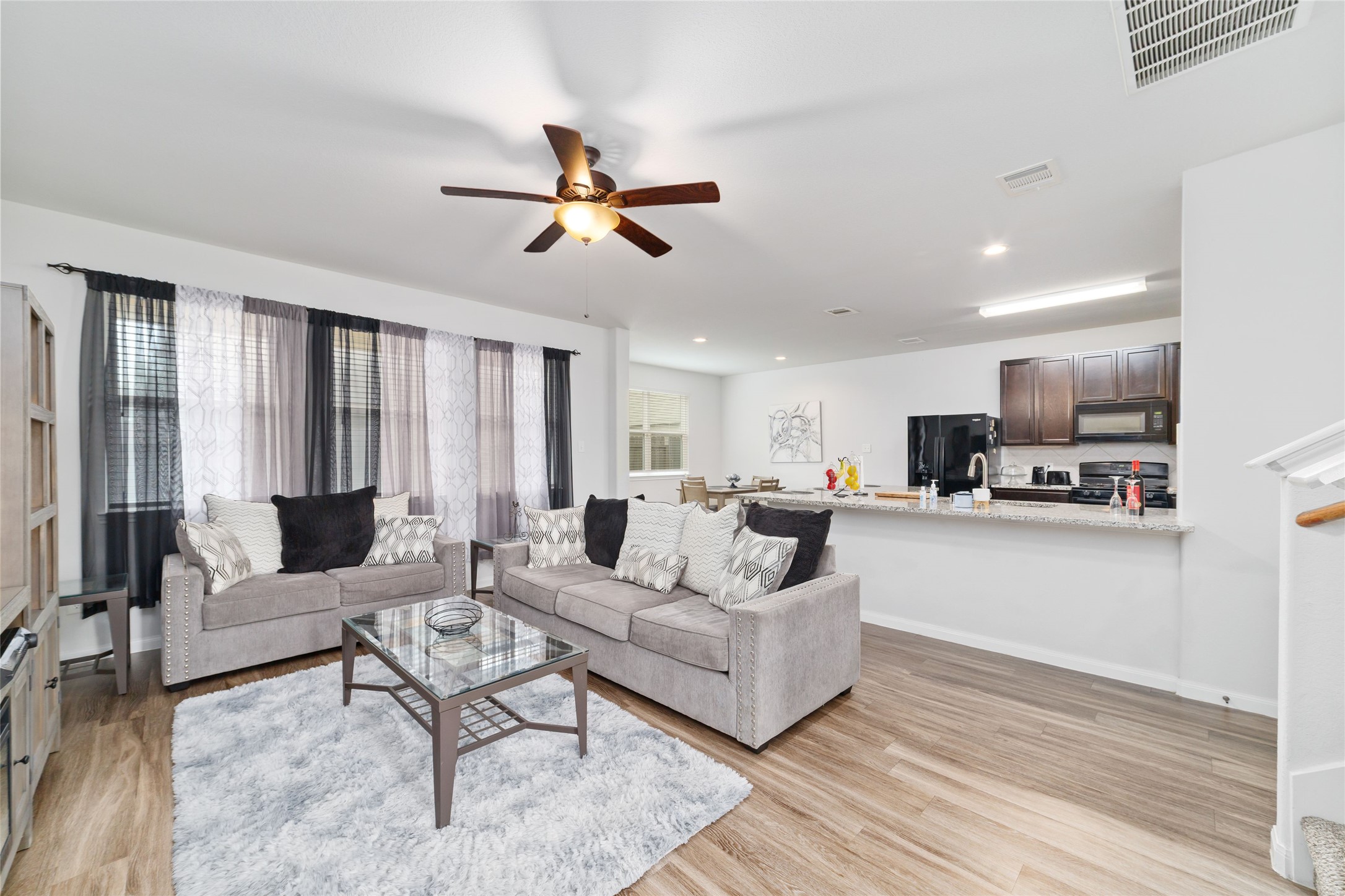 18619 Cooper Ravine Way Katy, TX 77449 - Photo 6 of 23 a living room with furniture and a view of kitchen