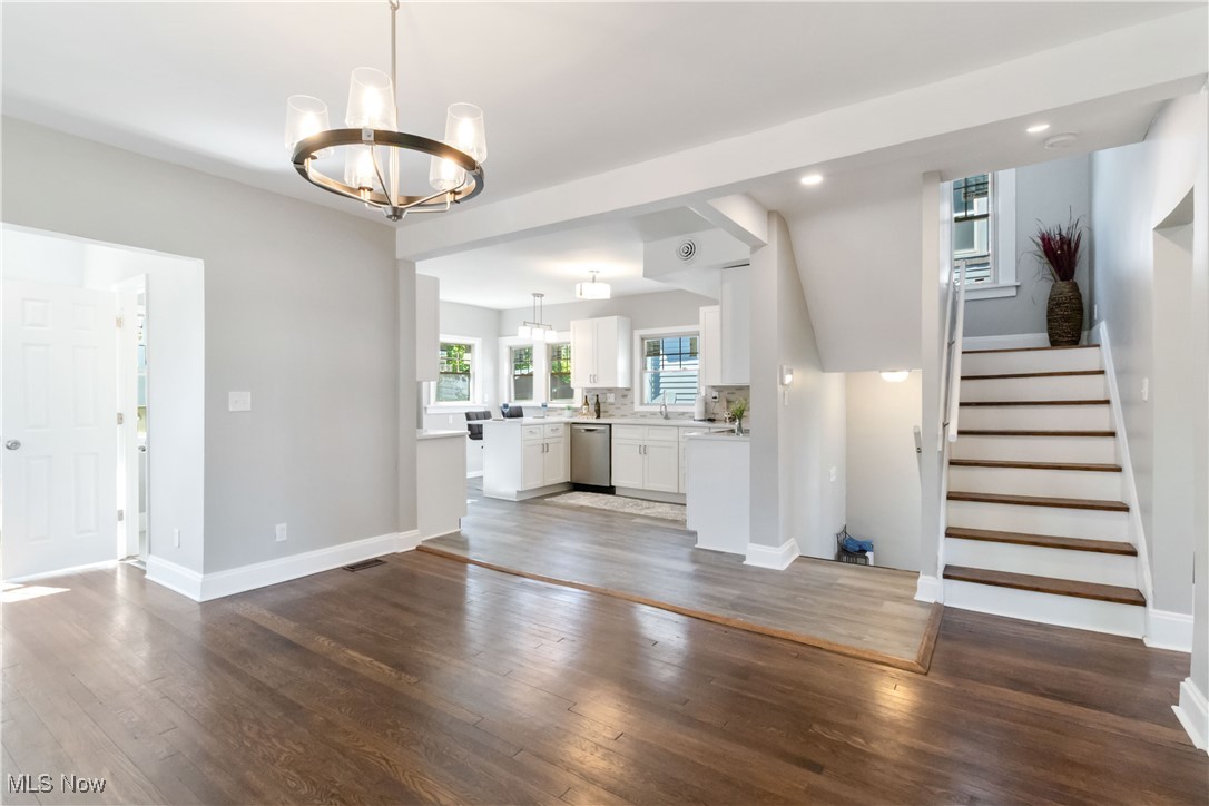 3566 Ludgate Road Cleveland, OH 44120 - Photo 10 of 27 Unfurnished living room featuring a chandelier, wood finished floors, baseboards, stairs, and recessed lighting