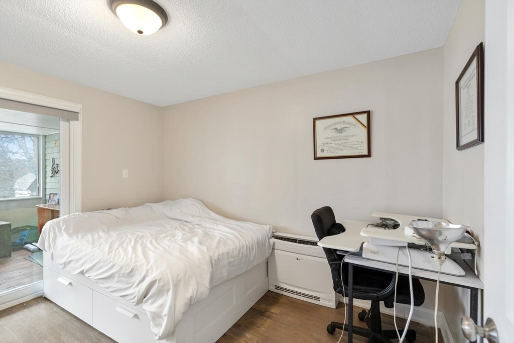 299 Asbury Street Hamilton, MA 01982 - Photo 12 of 37 a bedroom with a bed and a desk