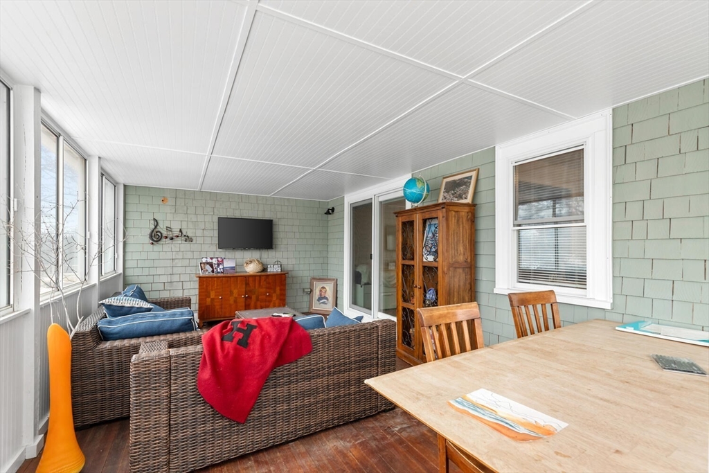 299 Asbury Street Hamilton, MA 01982 - Photo 15 of 37 a living room with furniture kitchen view and large windows