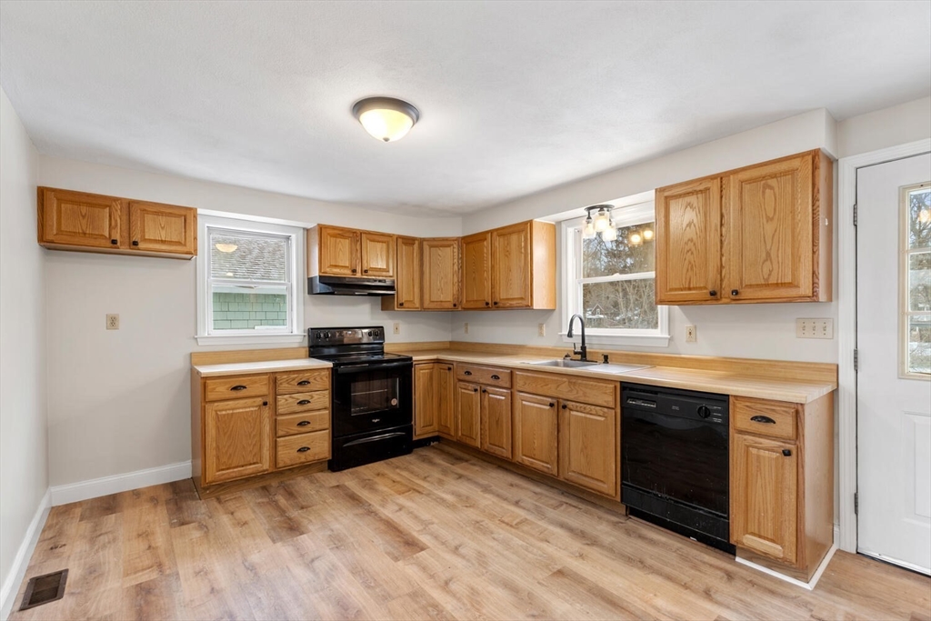 299 Asbury Street Hamilton, MA 01982 - Photo 20 of 37 a kitchen with stainless steel appliances granite countertop a stove sink and cabinets