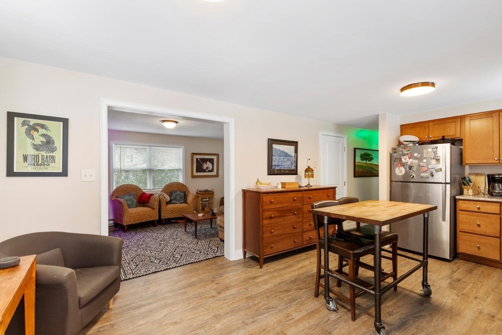 299 Asbury Street Hamilton, MA 01982 - Photo 2 of 37 a living room with furniture and a window