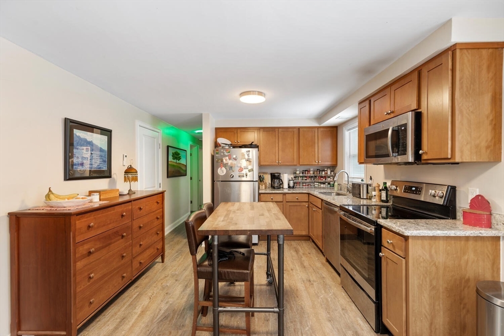 299 Asbury Street Hamilton, MA 01982 - Photo 3 of 37 a kitchen with stainless steel appliances a sink stove and refrigerator