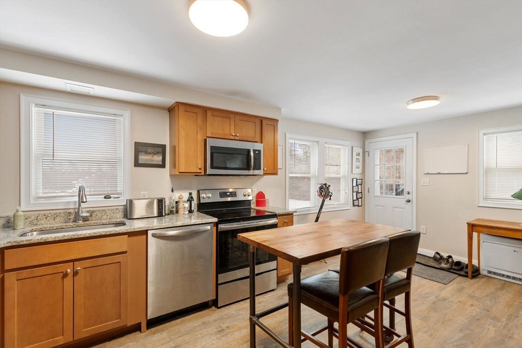 299 Asbury Street Hamilton, MA 01982 - Photo 5 of 37 a kitchen with a sink cabinets and wooden floor