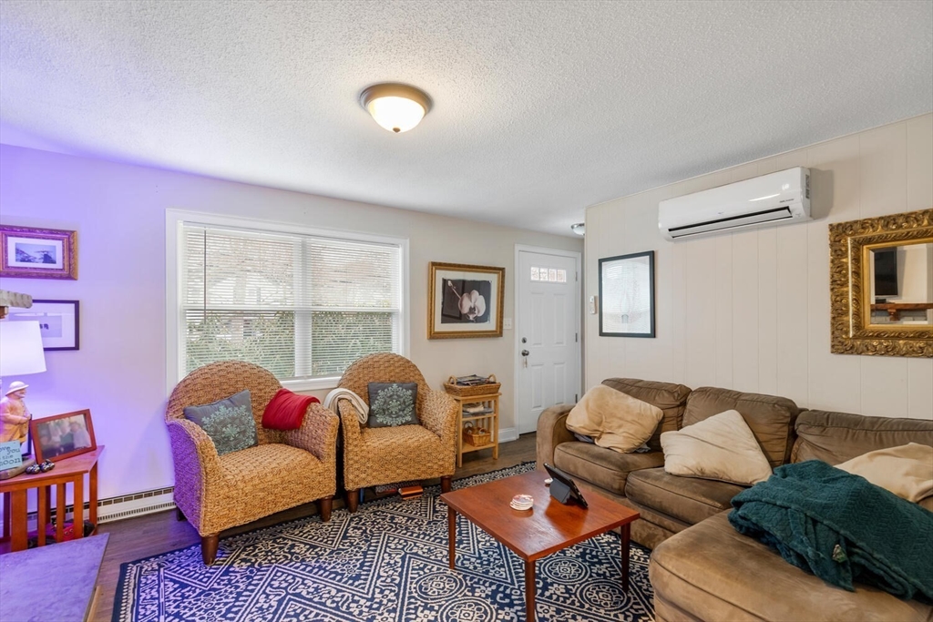 299 Asbury Street Hamilton, MA 01982 - Photo 7 of 37 a living room with furniture and a window