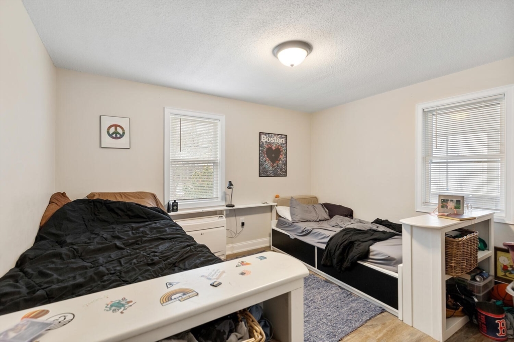 299 Asbury Street Hamilton, MA 01982 - Photo 10 of 37 a bedroom with a bed and a window