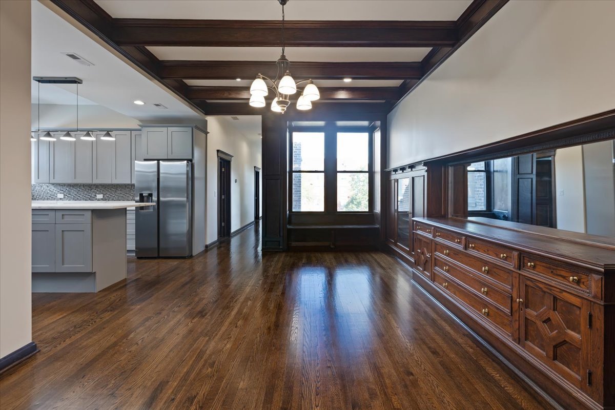 442-444 East 48th Street, Unit 2E Chicago, IL 60615 - Photo 16 of 28 a view of a hallway with wooden floor and chandelier