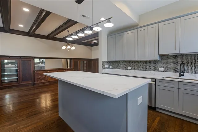 a kitchen with a counter space a sink and cabinets