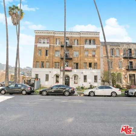 a buildings with car parked in front of it