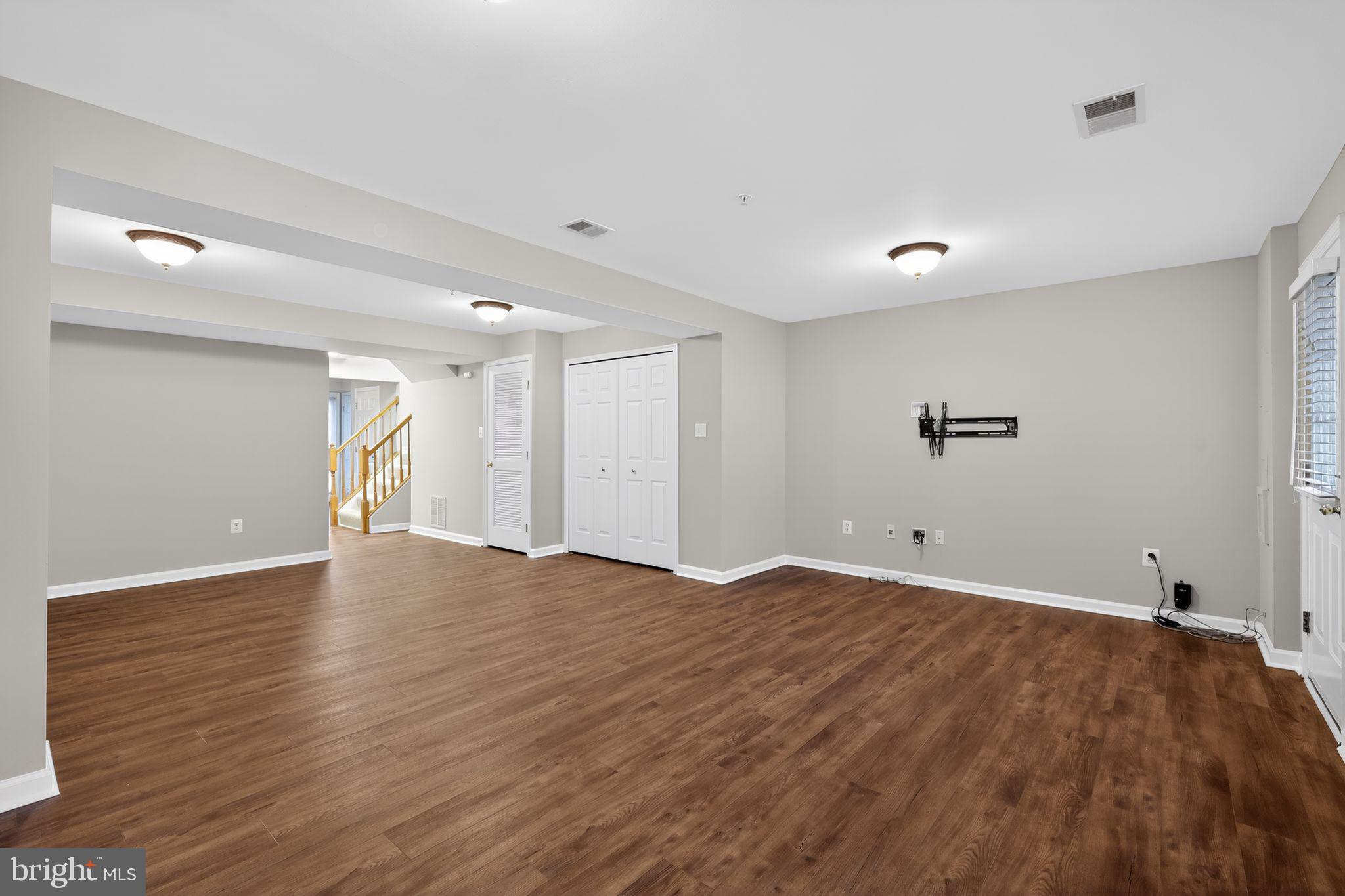 18707 Little Star Lane Germantown, MD 20874 - Photo 16 of 30 a view of an empty room with wooden floor and a window